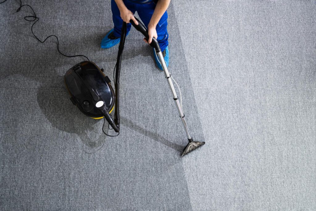 Professional carpet cleaning technician working in a bright San Jose living room during spring